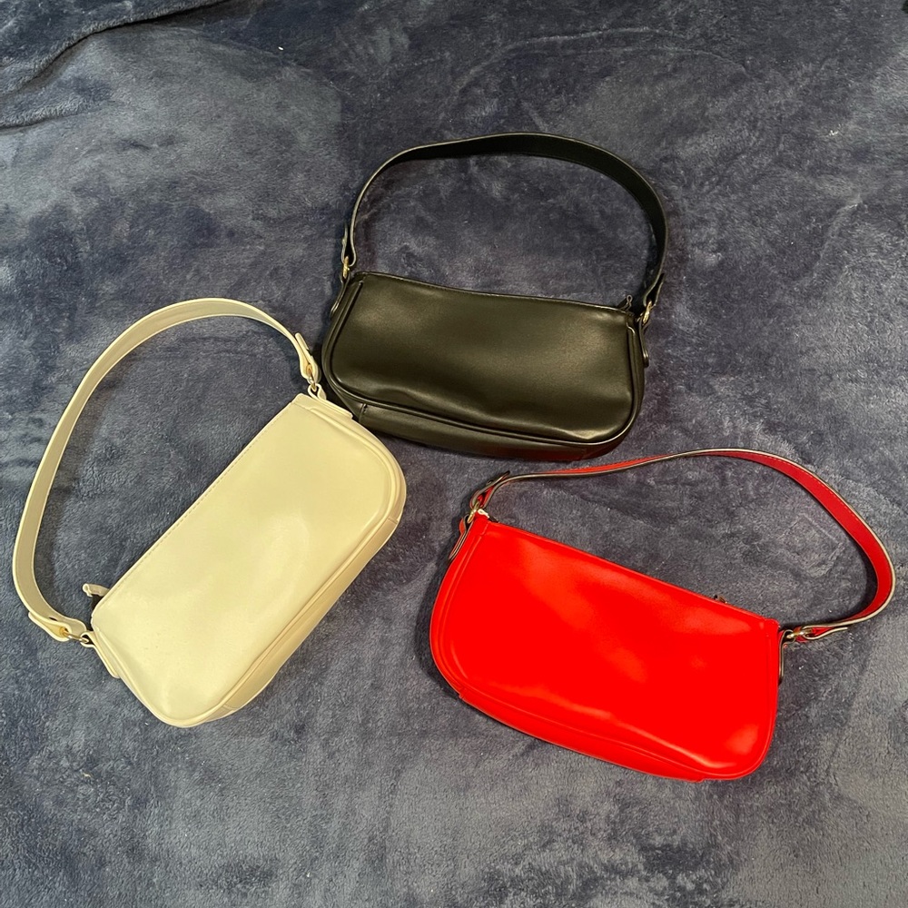 Small shoulder bags in red, white, and black